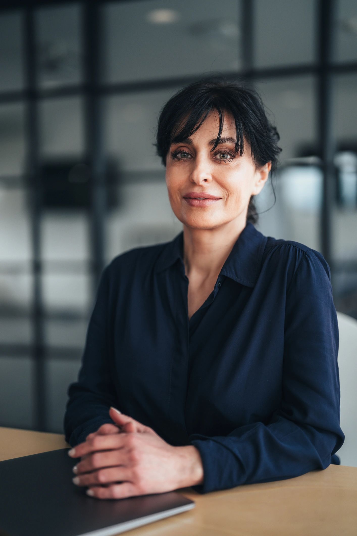 Professional real estate agent seated in a modern office